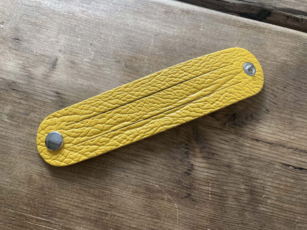 The WoggleMakers Scout Woggle Yellow / 10 Scouting Activity Packs - Unplaited Leather Woggles with instructions.
